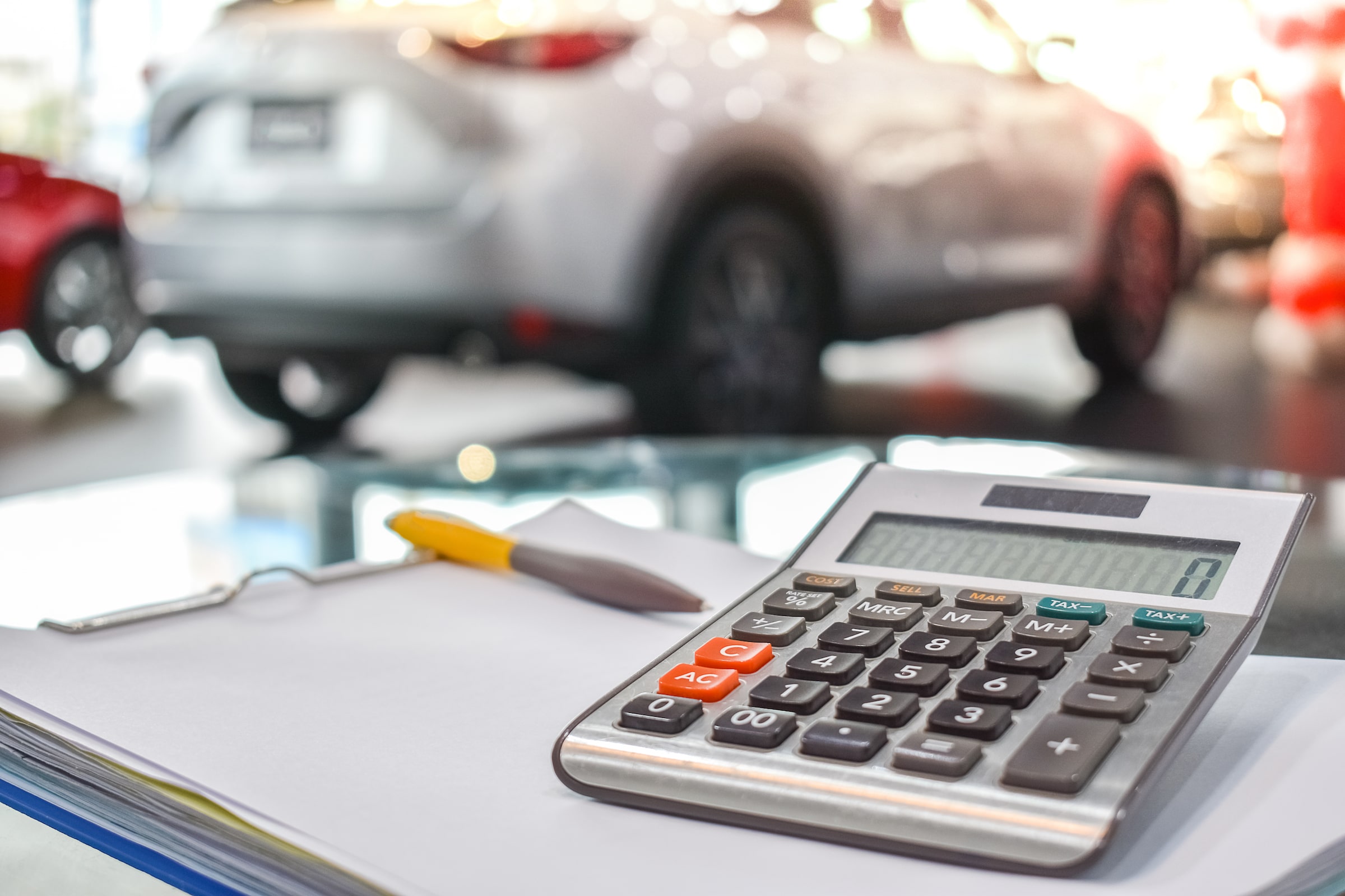 calculator with cars in the background