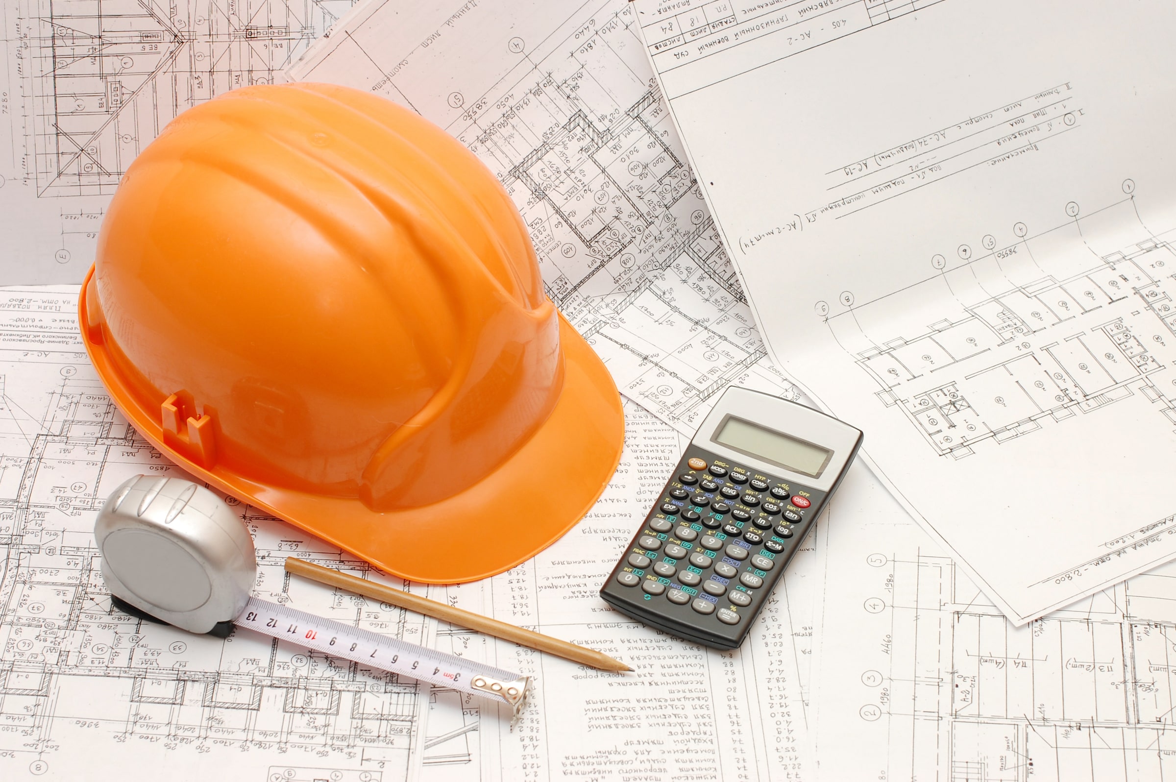 Hard hat with calculator and pencil